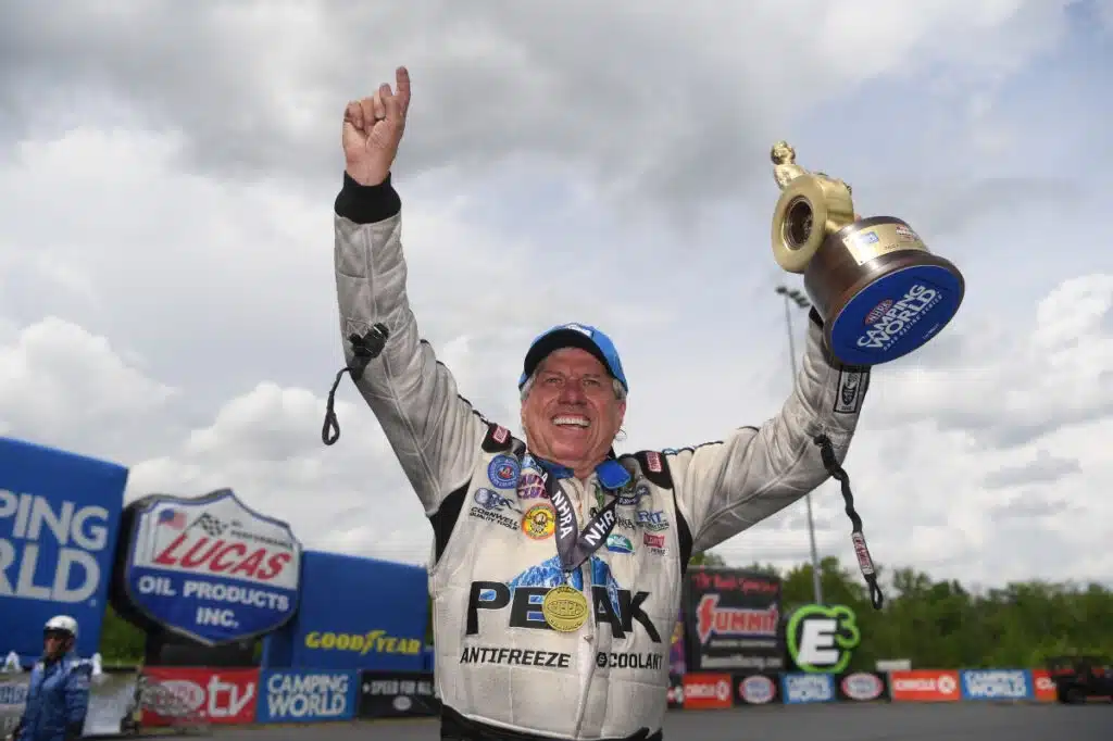 john force holding a trophy to celebrate a win